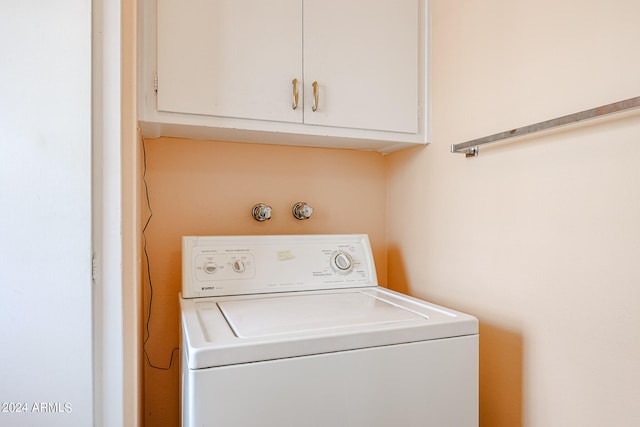 laundry area featuring washer / clothes dryer and cabinets