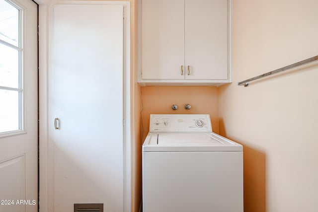 washroom featuring cabinets and washer / clothes dryer