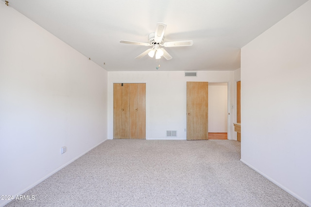 unfurnished bedroom featuring a closet, ceiling fan, and light carpet