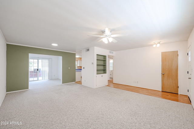 unfurnished living room with light wood-type flooring, ceiling fan, and crown molding