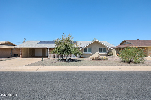 view of front facade featuring solar panels