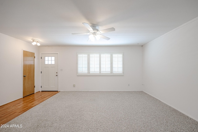 empty room featuring ceiling fan and light hardwood / wood-style floors