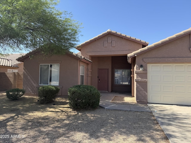 1930 W Burgess Ln, Phoenix, AZ 85041 - view of front of house featuring an attached garage, stucco siding, and a tiled roof