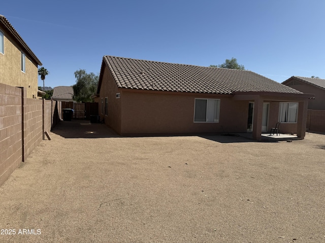1930 W Burgess Ln, Phoenix, AZ 85041 - rear view of property with a tile roof, stucco siding, and a patio