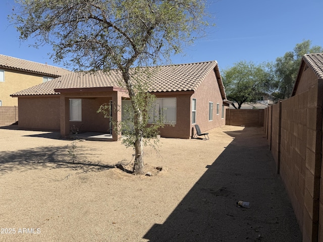 1930 W Burgess Ln, Phoenix, AZ 85041 - back of property with a tile roof, a fenced backyard, and stucco siding