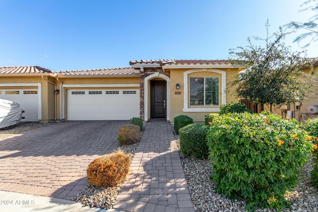 mediterranean / spanish house featuring a garage