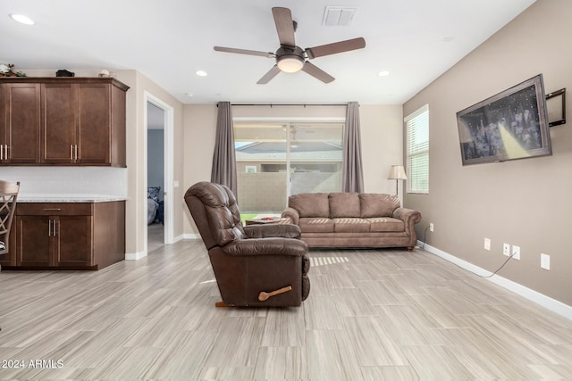 living room featuring ceiling fan and light hardwood / wood-style flooring