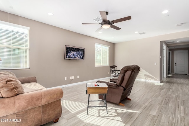 living room featuring ceiling fan and light wood-type flooring