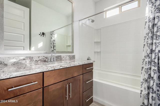 bathroom featuring shower / bath combo and vanity