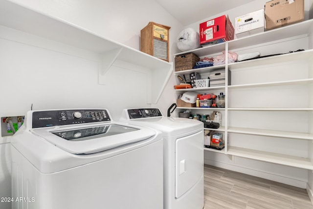 washroom featuring washer and dryer and wood-type flooring