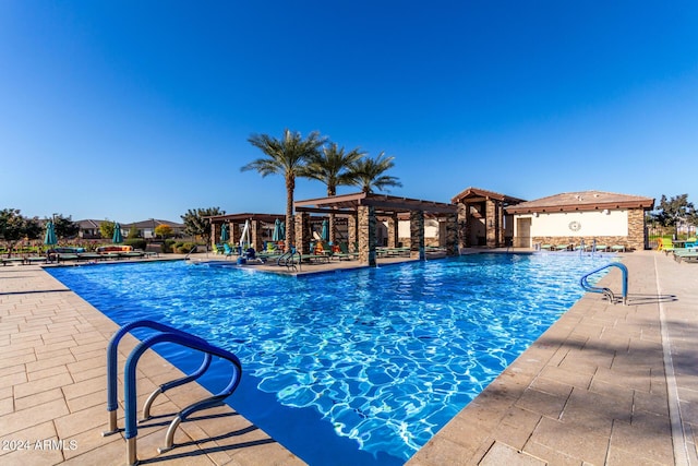 view of swimming pool featuring a pergola and a patio