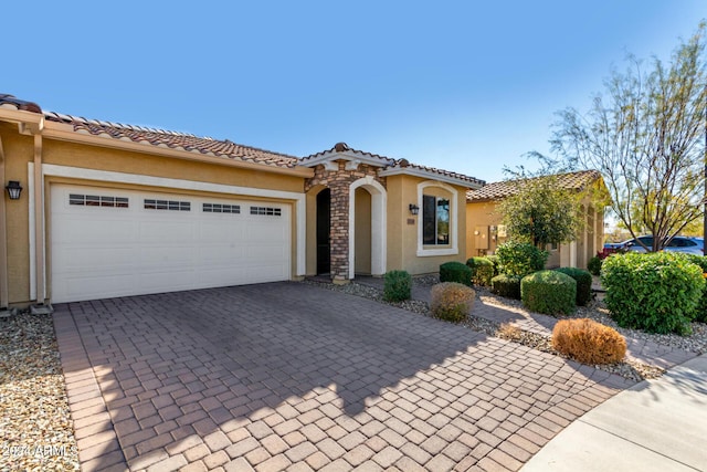 mediterranean / spanish-style house with a garage