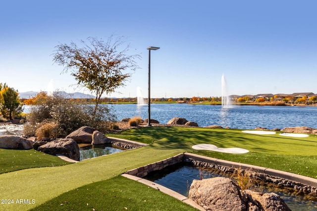 surrounding community featuring a water view