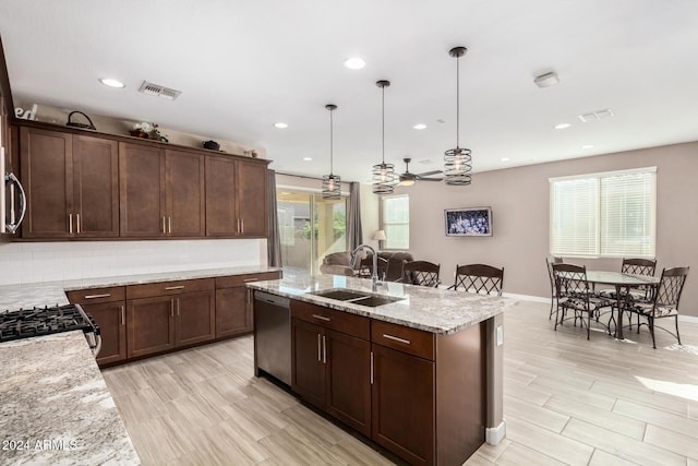 kitchen featuring pendant lighting, a healthy amount of sunlight, sink, and stainless steel appliances