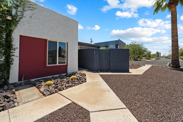 3551 N 12th St Unit 101, Phoenix, AZ 85014 - view of side of property featuring a gate and stucco siding