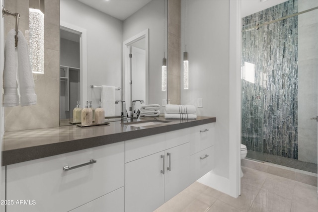 bathroom with toilet, walk in shower, tile patterned floors, and vanity