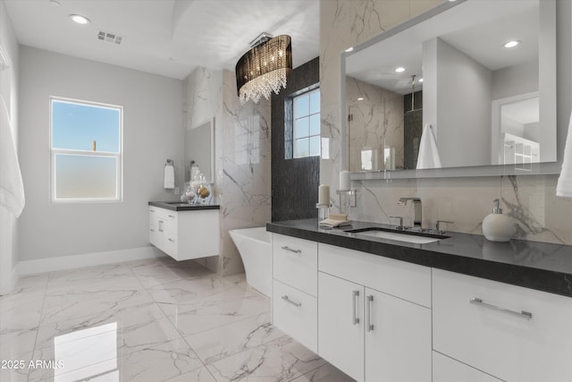 bathroom featuring a shower, a wealth of natural light, decorative backsplash, and vanity