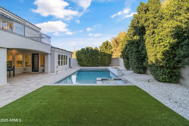 view of pool featuring a patio area and a lawn