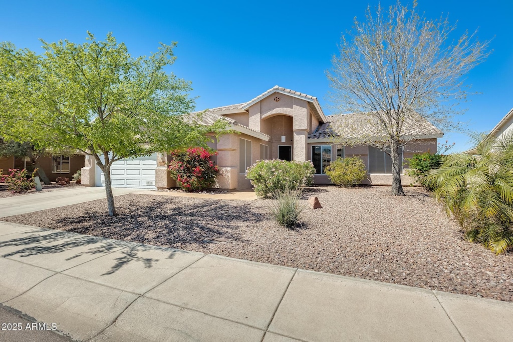 20630 N 42nd Ave, Glendale, AZ 85308 - view of front of home with a tile roof, a garage, driveway, and stucco siding