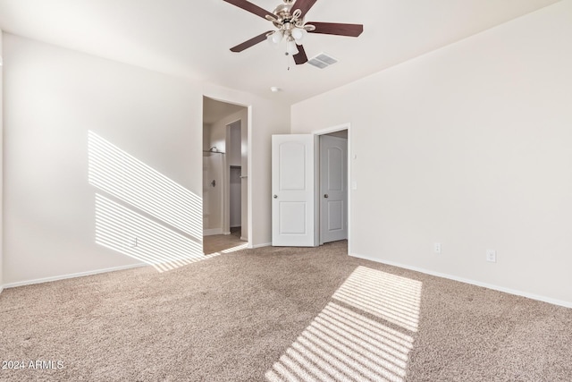 carpeted spare room featuring ceiling fan