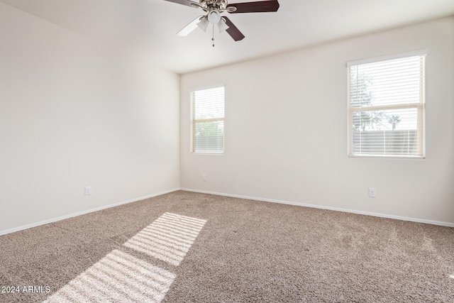 carpeted spare room with ceiling fan