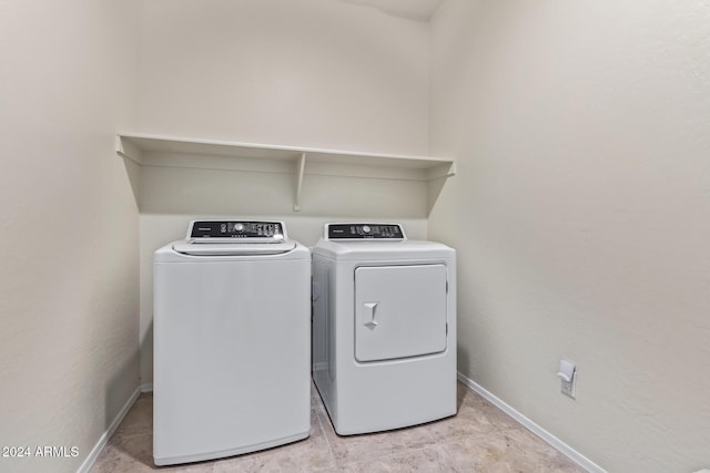 clothes washing area with washing machine and clothes dryer