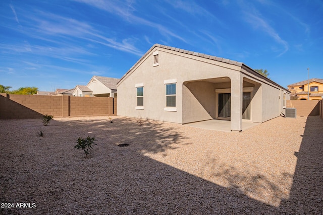 back of house featuring cooling unit and a patio area