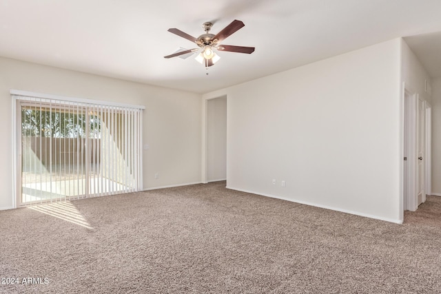 carpeted spare room featuring ceiling fan