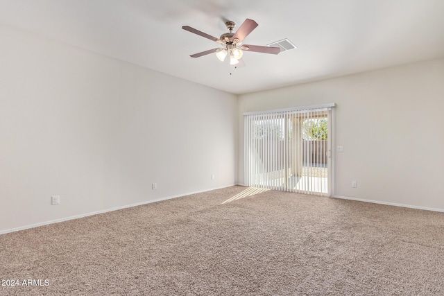 carpeted spare room with ceiling fan