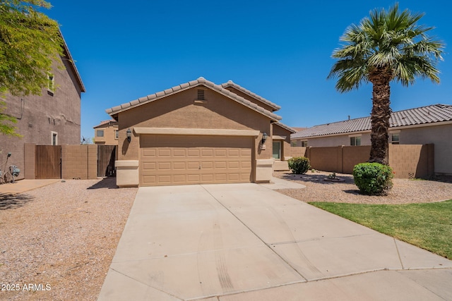 1956 N Hubbard Ln, Casa Grande, AZ 85122 - view of front facade with fence, stucco siding, a gate, an attached garage, and driveway