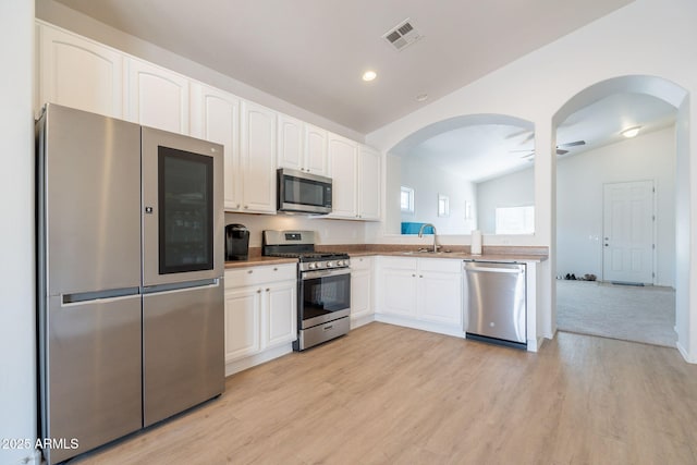 1956 N Hubbard Ln, Casa Grande, AZ 85122 - kitchen with a sink, arched walkways, lofted ceiling, and stainless steel appliances