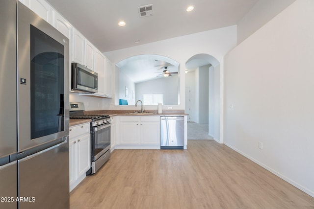 1956 N Hubbard Ln, Casa Grande, AZ 85122 - kitchen featuring ceiling fan, appliances with stainless steel finishes, white cabinetry, a sink, and light wood-style flooring
