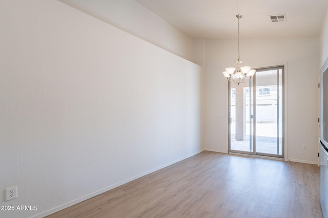 1956 N Hubbard Ln, Casa Grande, AZ 85122 - spare room with baseboards, visible vents, an inviting chandelier, and light wood finished floors
