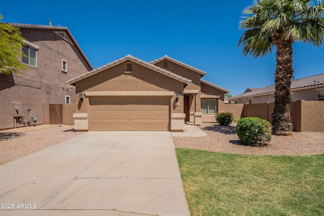 1956 N Hubbard Ln, Casa Grande, AZ 85122 - view of front of home featuring fence, a tile roof, a garage, stucco siding, and driveway