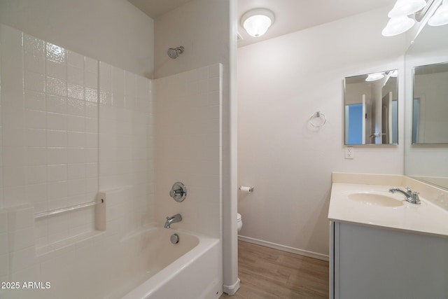 1956 N Hubbard Ln, Casa Grande, AZ 85122 - full bathroom featuring vanity, wood finished floors, toilet, baseboards, and shower / tub combination