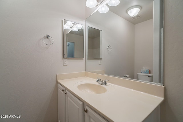 1956 N Hubbard Ln, Casa Grande, AZ 85122 - bathroom with visible vents, a textured wall, and vanity