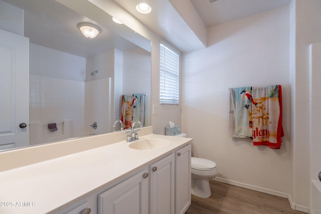 1956 N Hubbard Ln, Casa Grande, AZ 85122 - full bathroom with baseboards, vanity, toilet, and wood finished floors