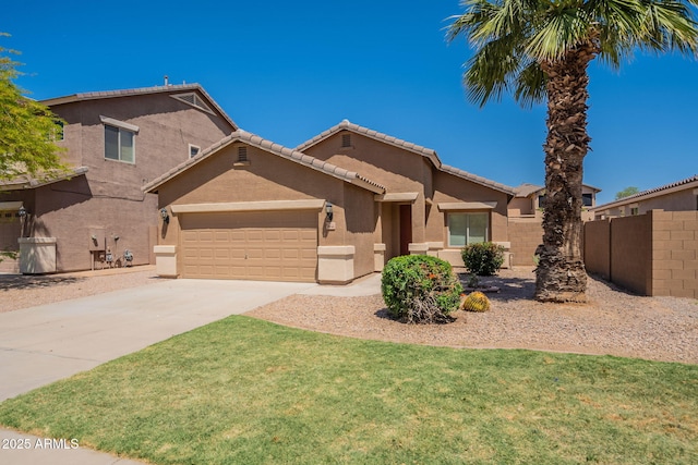 1956 N Hubbard Ln, Casa Grande, AZ 85122 - view of front facade featuring a front lawn, fence, stucco siding, an attached garage, and driveway