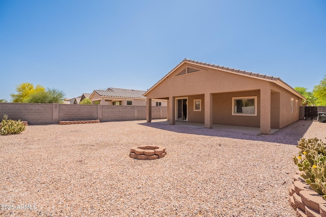 1956 N Hubbard Ln, Casa Grande, AZ 85122 - rear view of property with a patio, a fenced backyard, a fire pit, and stucco siding