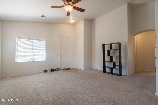 1956 N Hubbard Ln, Casa Grande, AZ 85122 - unfurnished room with visible vents, a ceiling fan, carpet flooring, baseboards, and arched walkways