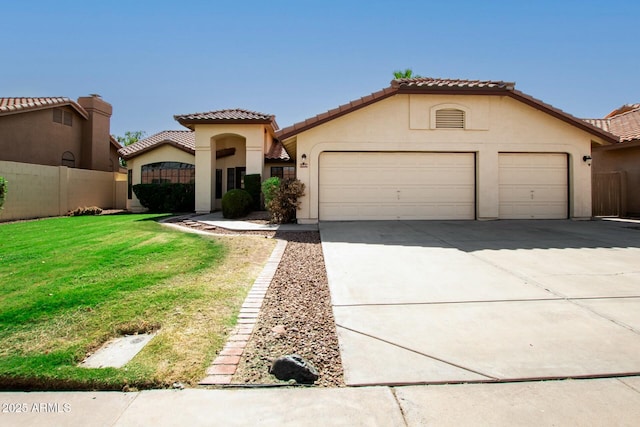 mediterranean / spanish-style home with a garage and a front yard