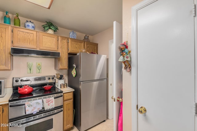 kitchen featuring stainless steel appliances and range hood