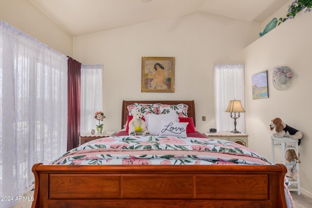 bedroom featuring carpet flooring and lofted ceiling