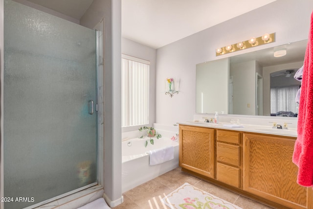 bathroom featuring plus walk in shower, double sink vanity, and tile patterned floors