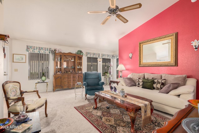 carpeted living room with ceiling fan and lofted ceiling