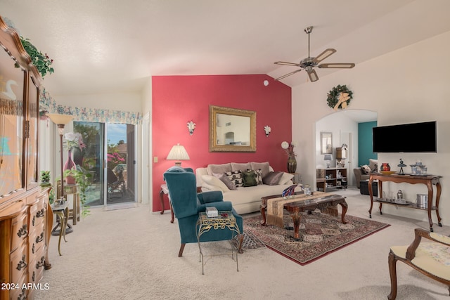 living room featuring light colored carpet, vaulted ceiling, and ceiling fan