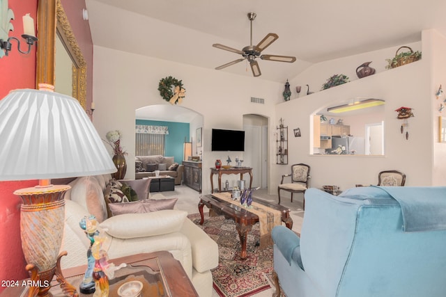 living room featuring ceiling fan, carpet flooring, and vaulted ceiling