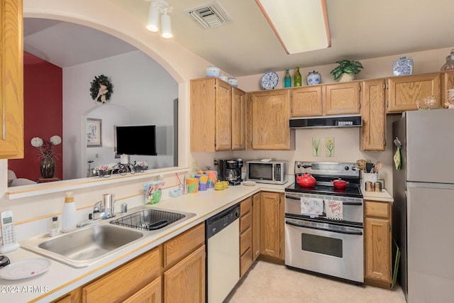 kitchen with sink, light tile patterned flooring, and stainless steel appliances