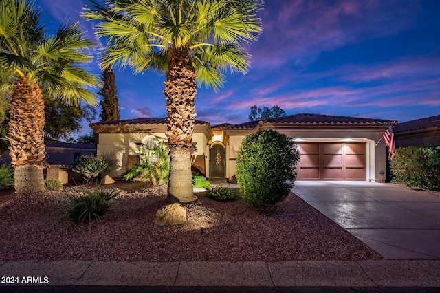 mediterranean / spanish-style home featuring a garage