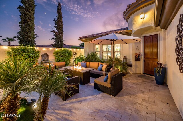 patio terrace at dusk featuring an outdoor living space